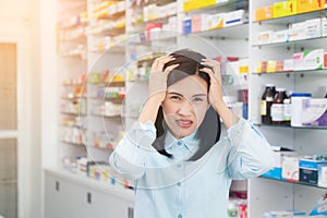 Female patient having head ache background  pharmacy. Woman feeling unwell Healthcare and medical concept
