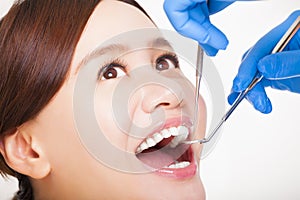 female patient having teeth examined by dentist