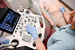 Female patient having ultrasound procedure in medical center.