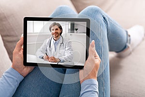 Female patient having video chat with doctor on digital tablet at home