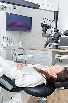 Female patient laying in dental chair befor treating
