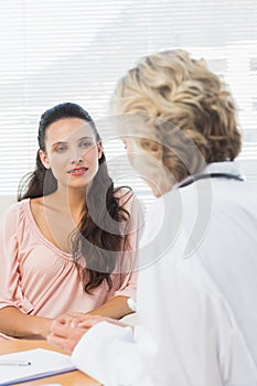 Female patient listening to doctor with concentration