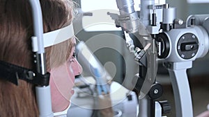 Female patient on medical attendance at the optometrist. Contemporary modern medical equipment.