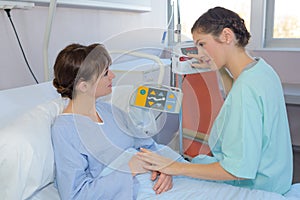 Female patient and nurse have consultation in hospital room