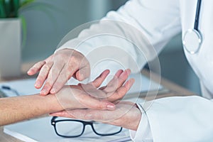 Female patient at orthopedic doctor medical exam for wrist injur