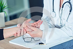 Female patient at orthopedic doctor medical exam for wrist injur