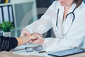 Female patient at orthopedic doctor medical exam for wrist injur