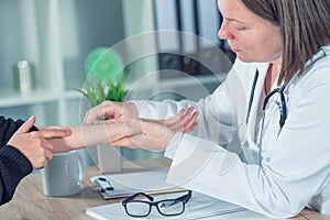 Female patient at orthopedic doctor medical exam for wrist injur