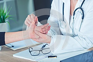 Female patient at orthopedic doctor medical exam for wrist injur