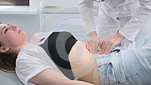 Female patient receiving physical therapy for back pain in clinic during day