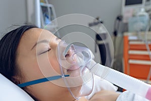 Female patient resting in bed in ward at hospital