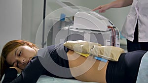 A female patient sleeps during physiotherapy.