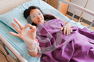Female patient sowing cheerful ok hand sign
