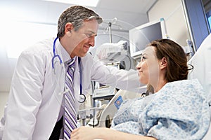 Female Patient Talking To Male Doctor In Emergency Room