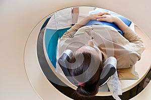 Female patient undergoing MRI - Magnetic resonance imaging in Hospital. Medical Equipment and Health Care concept