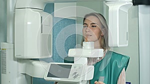 Female patient undergoing tests on dental X-Ray scanner