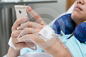 Female Patient Using Mobile Phone on Bed