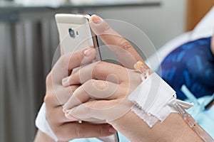 Female Patient Using Mobile Phone In Hospital