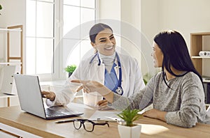 Female patient visiting a doctor at the medical office during medical examination.