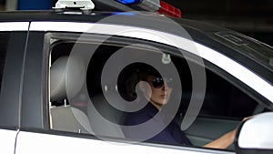 Female patrolwoman driving police car, traffic laws patrolling, monitoring order