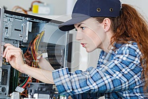 female pc technician checking pc cables