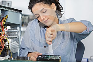 female pc technician working on desktop computer