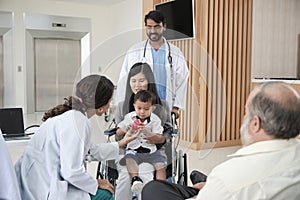 Female pediatric doctor teasing boy for examination at hospital.