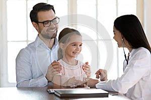 Female pediatrician consult little girl patient in hospital