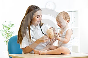 Female pediatrician examining of child in hospital