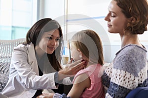Female Pediatrician Examining Child In Hospital photo