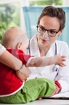 Female pediatrician with little patient