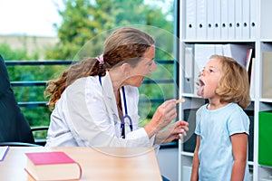 Female pediatrician in white lab coat examined little patient