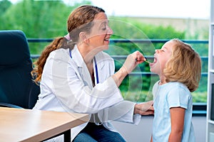 Female pediatrician in white lab coat examined little patient