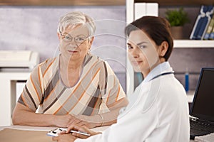 Female pensioner at doctors office photo