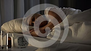 Female pensioner sleeping in bed, nursing home lifestyle, pensioner night rest