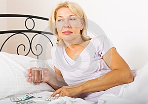 Female pensioner taking medicine