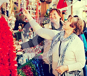 Female pensioners buying X-mas decorations