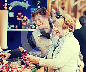 Female pensioners buying X-mas decorations