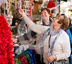 Female pensioners buying X-mas decorations