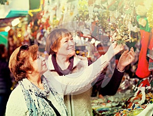 Female pensioners buying X-mas decorations