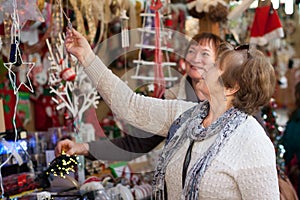 Female pensioners buying X-mas decorations at fair