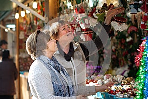 Female pensioners buying X-mas decorations at fair