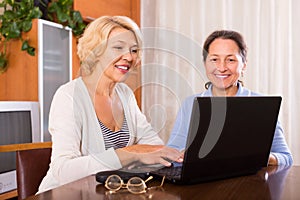 Female pensioners with laptop indoor