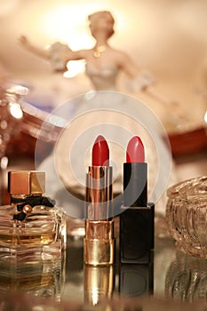 Female perfume and two lipsticks