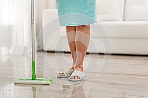 Female person cleaning flooring in house