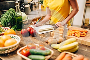 Female person cooking on the kitchen, bio food photo