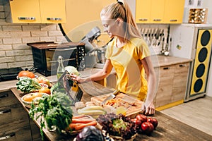 Female person cooking on the kitchen, healthy food