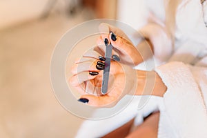 Female person hands with nail file, manicure photo