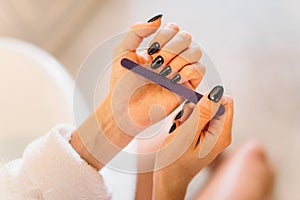 Female person hands with nail file, manicure photo