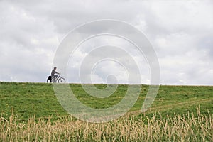 Profile of middle aged woman riding bike photo